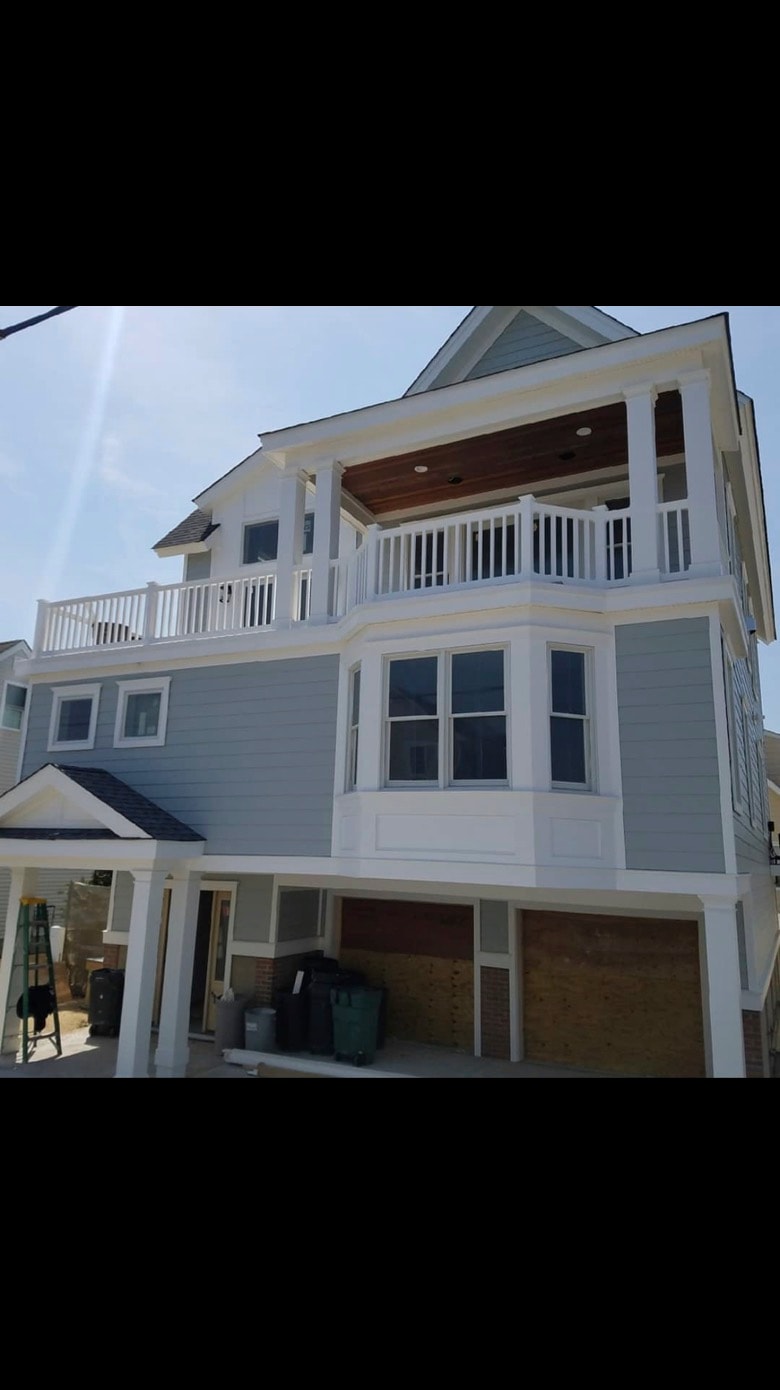 Custom home gray siding with balcony — Cole James Builders NJ
